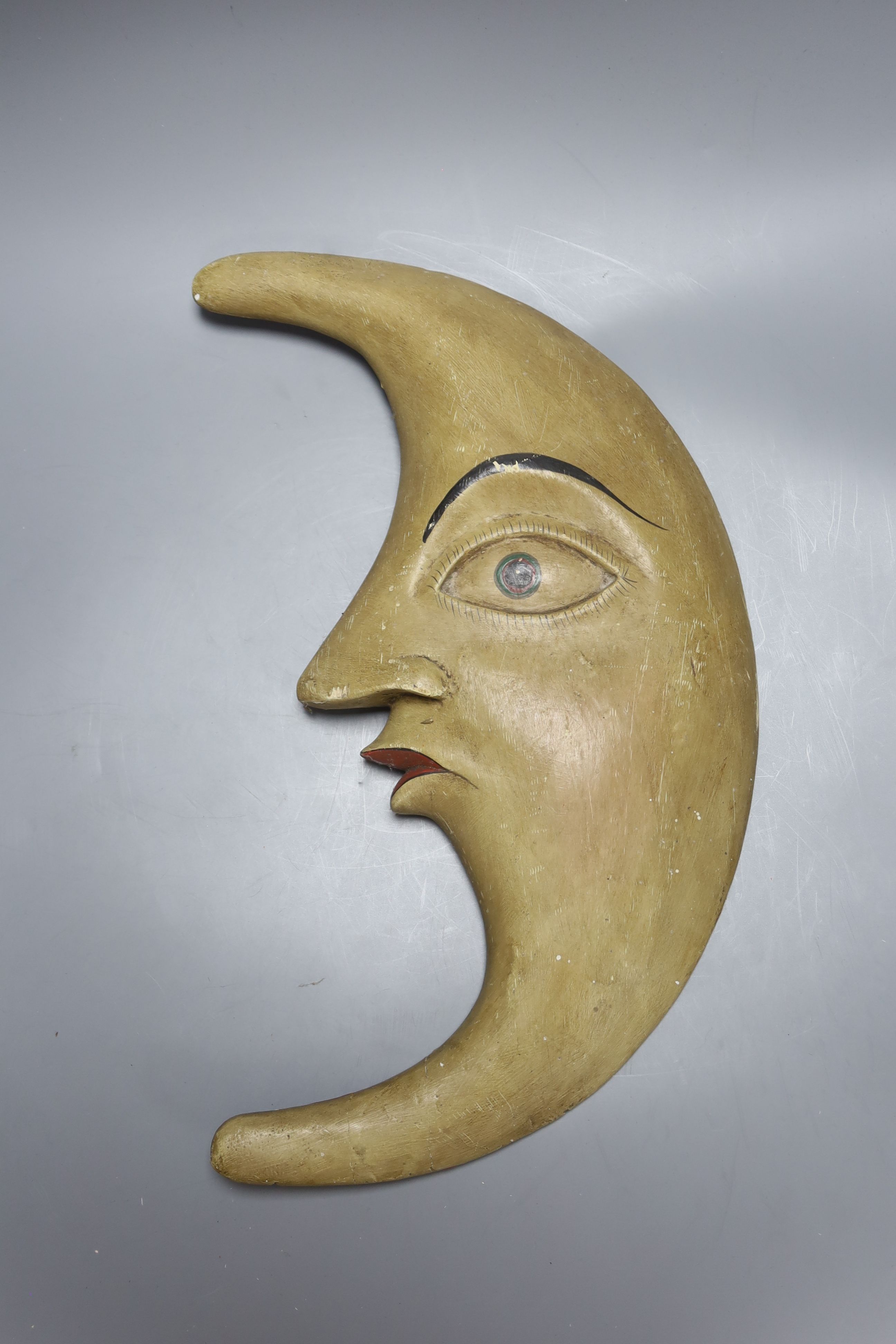 A Continental printed wood crescent Man in the Moon plaque, back inscribed CWL 1910 MAYEN